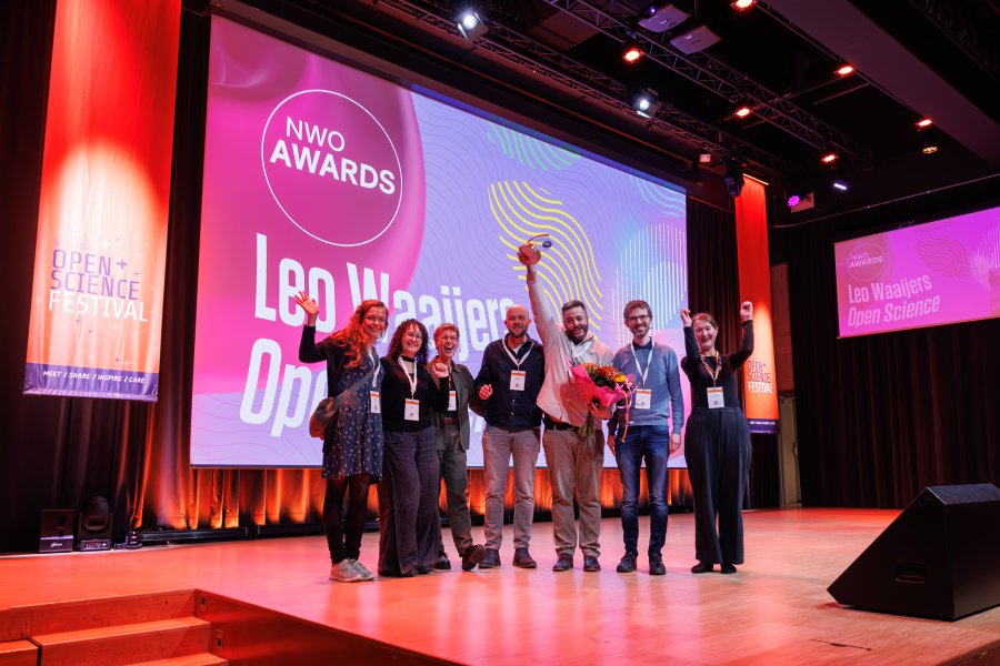 The FORRT team poses with the award on stage