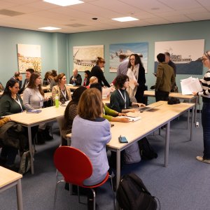 A group of people attending the first workshop round